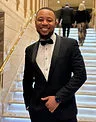 Person dressed in a formal suit, blazer, and bow tie